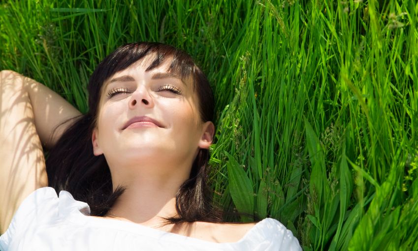 happy woman in grass istock
